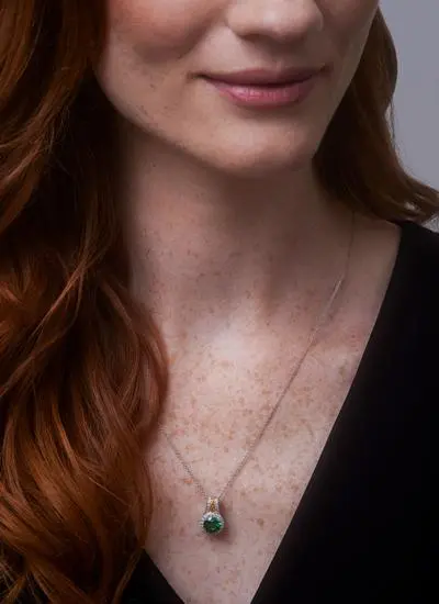 Close up shot of red haired model wearing Celtic Silver Green Stone Halo Pendant